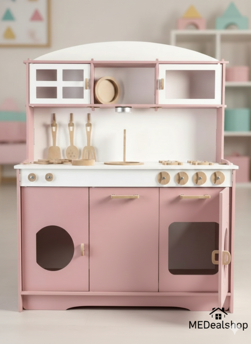 Pink and white children's play kitchen set with utensils on a light background